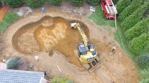 DJI_0033 Backhoe in Excavation site for a new Custom Pool